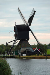 Fototapeta premium A proof of Dutch engineering in the 17th century, a windmill to pump the water out of the land. UNESCO world heritage site.
