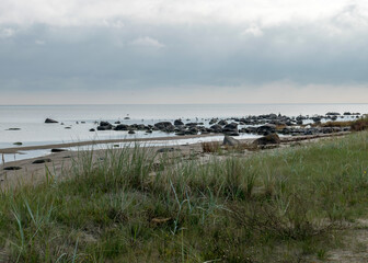 The unusual landscape of Kaltene beach, formed by large boulders covering the coast, morning hour, Kaltene rocky seashore, Latvia