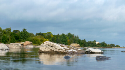 The unusual landscape of Kaltene beach, formed by large boulders covering the coast, morning hour, Kaltene rocky seashore, Latvia