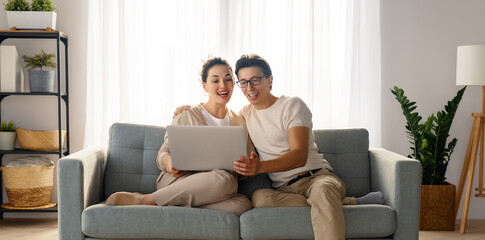 young couple is using laptop