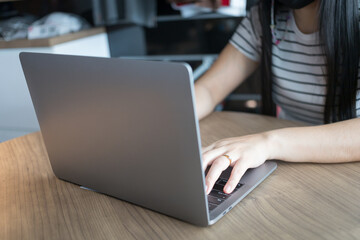 Working from home on laptop while typing chat to customer communicates on internet in home office