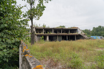 abandoned building, abandoned housing, crumbling buildings, dilapidated, abandoned house Dilapidated, surrounded by bushes and trees, broken fence selective focusing