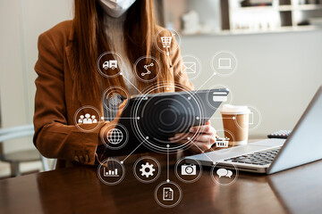 businesswoman hand working with  laptop computer and tablet in modern office with virtual icon