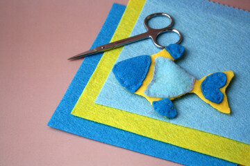 A children's toy made of felt. Blue and yellow fish made of fabric. Creativity with children. DIY...