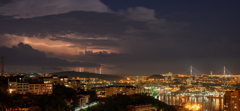 Lightning storm at night over city.