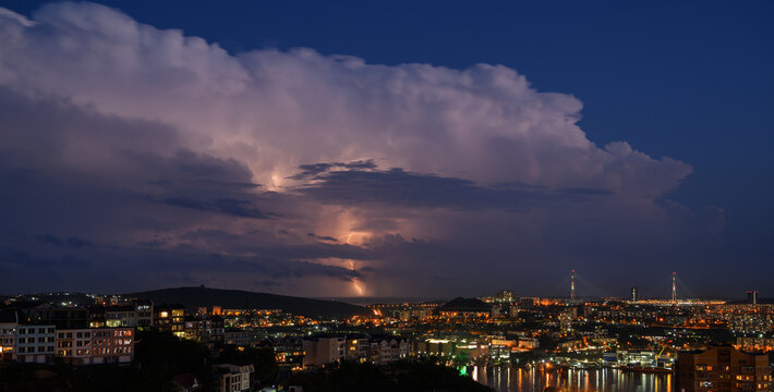 Lightning storm at night over city.