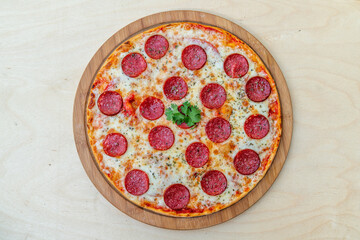 Fresh flavorful pepperoni pizza on wood.
