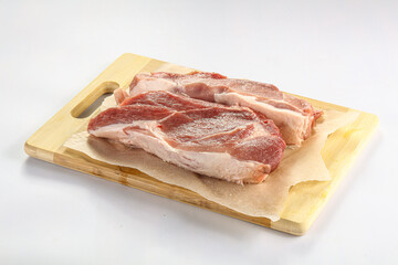 Raw pork fillet over board