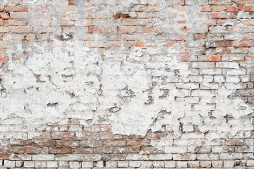 Texture of damaged old brick wall with weather worn surface as background