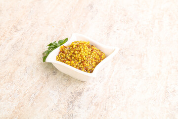Grain mustard sauce in the bowl