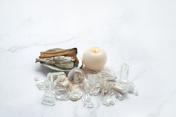 Clear quartz minerals, candle, palo santo, white sage bundle on abalone sea shell. incense for...