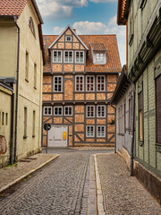 Fototapeta na wymiar Quedlinburg,Saxony-Anhalt, Germany. 06 July 2021. small town with old vintage small colored houses and old cobblestone pavement. UNESCO World Heritage city