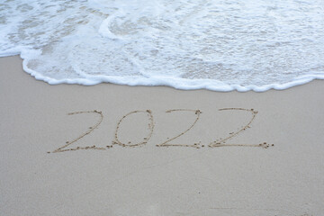 Written 2022 on the beach sand with soft wave.