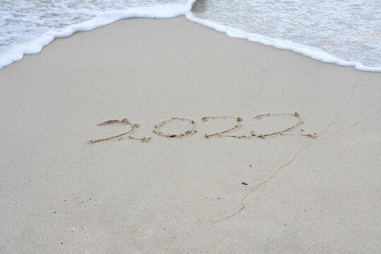 Written 2022 on the beach sand with soft wave.