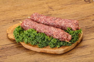 Raw minced beef kebab skewer