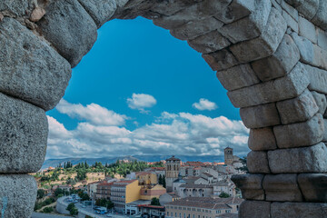 arch of the aqueduct of Segovia historical monument with city in the background - Powered by Adobe
