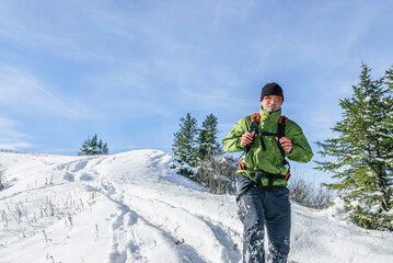 Wanderer beim Abstieg über einen verschneiten Hang