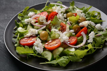 Greek salad of fresh cucumber, tomato, lettuce, red onion, feta cheese and olives with olive oil.