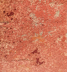 Old red plaster on the wall.