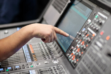 operator controls digital audio mixing console