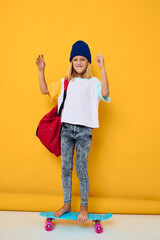 schoolgirl with a skateboard on his head yellow background