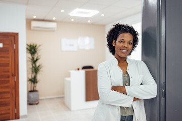 Portrait of a smiling general practitioner at medical clinic.