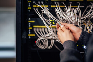 Working on connection procedure at data center. Checking connector.
