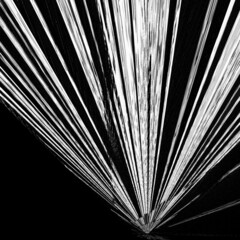 many pink purple and white stripes travelling at high speed to a far distant vanishing point on a plain dark background