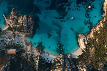Naklejka na ściany i meble View from above, stunning aerial view of Spargi Island with Cala Corsara, a white sand beach bathed by a turquoise water. La Maddalena archipelago National Park, Sardinia, Italy.