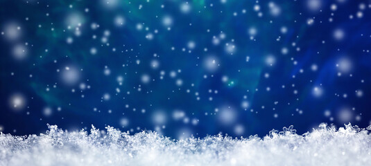 Natural snow texture with snowflakes close-up with falling snow on a blue background and free copy space for text. Christmas card template . Macro texture of snow. Large size.