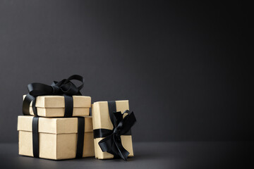 Black Friday background with gift boxes on black surface