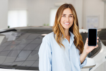 Woman customer female buyer client wears blue shirt use mobile phone blank screen choose auto want...