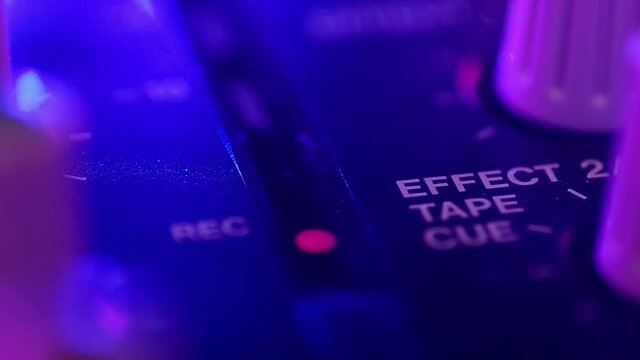 Macro closeup. Portative cassette tape studio mixer. Sign Effect and blinking record LED light. Deep blur bokeh.