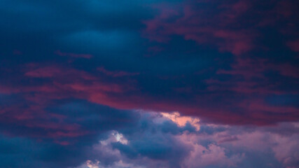 Fototapeta na wymiar Purple and blue clouds at twilght or dusk. Dramatic clouds background