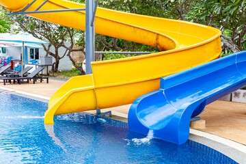 Blue yellow slides at the pool inside a luxury hotel.