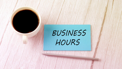 BUSINESS HOURS text on blue sticker with cofee and pen