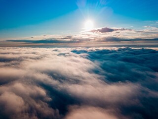 Naklejka na ściany i meble High flight over the fog in the mountains. Ukrainian Carpathians in the morning. Aerial drone view.