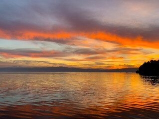 Fantastic colors of the sunset, colorful clouds and sky reflection on the surface of the water, magic lake, natural background, wallpaper