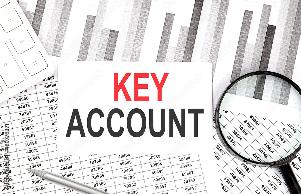Poster key account text on paper with calculator,magnifier ,pen on graph background