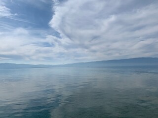 Amazing lake surface, transparent water, reflection, abstract sea background