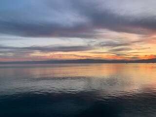 Fantastic colors of the sunset, colorful clouds and sky reflection on the surface of the water, magic lake, natural background, wallpaper