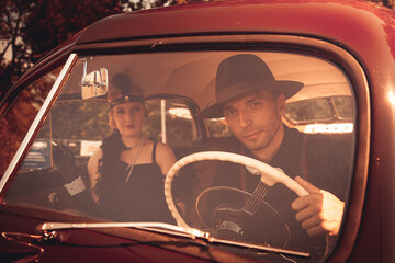 Young couple in retro car