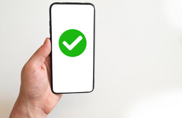 green check mark on smartphone screen.
green checkmark showing approved,completed,approved...