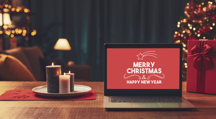 Merry Christmas and Happy New Year wishes on a laptop