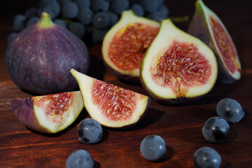 Fresh figs with grapes on a wooden table