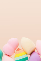 Cosmetic beauty blender sponges Green, violet, pink, rainbow colored make-up puffs different shape close up
