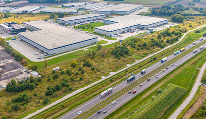 Aerial view of goods warehouse. Logistics delivery  center in industrial city zone from above....