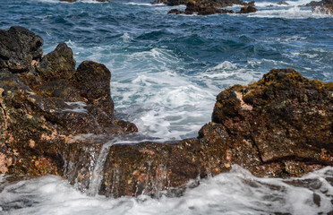 Waves hitting the rocks. Rocky cliffs on sea, seascape.