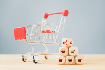 turned cube graph icon to red target side with blurred red shopping cart , for sale target or goal...
