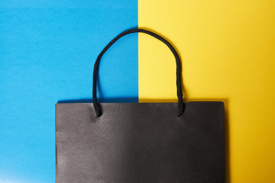 Paper shopping bag on colorful background